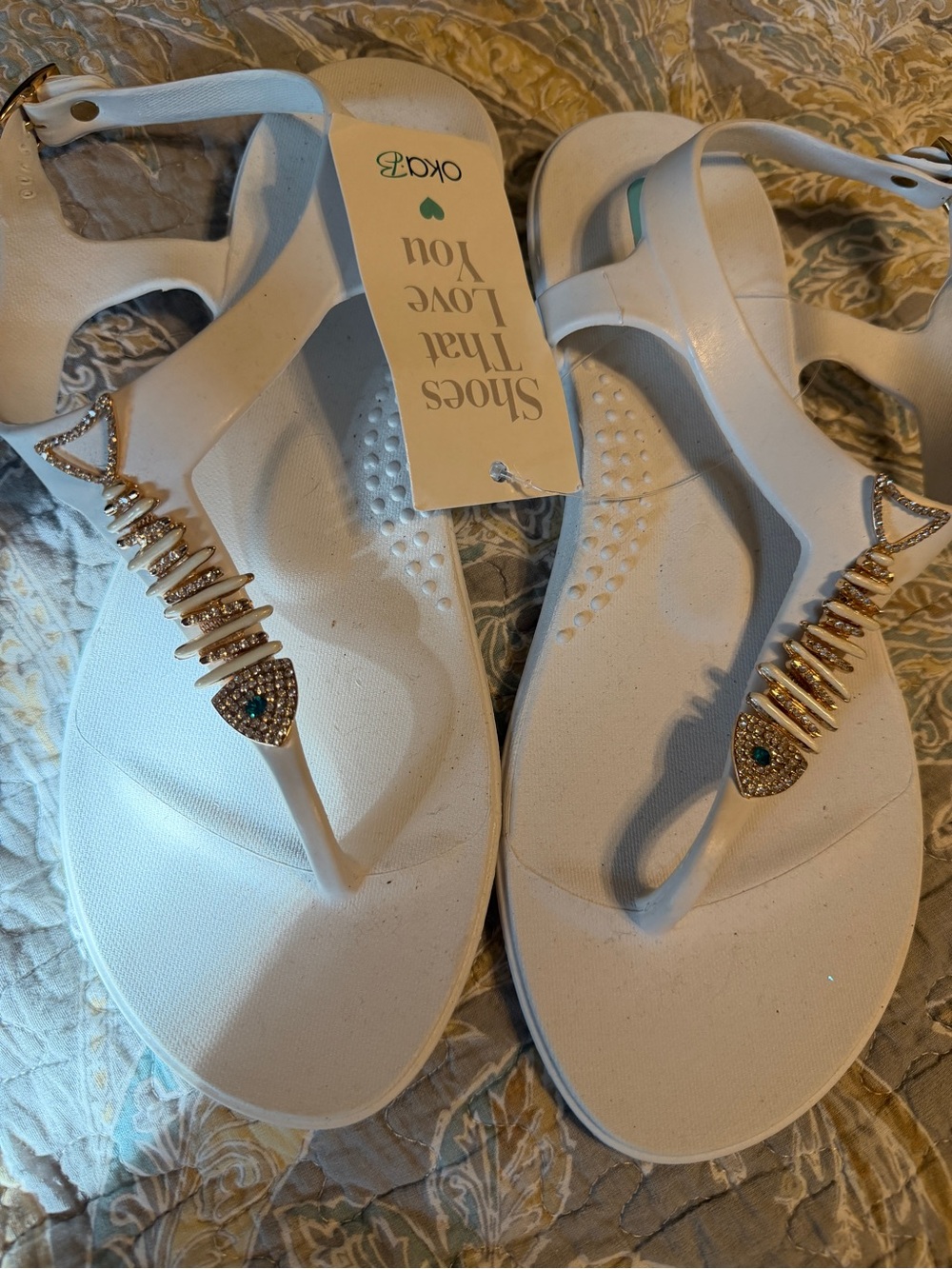 Okabashi White T-Strap Sandals with Gold Crystal Fishbone Accent